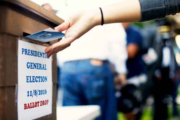 A woman drops her ballot during the presidential election at LA County Registrar Office in Norwalk, California, U.S., November 8, 2016.  REUTERS/Mario Anzuoni