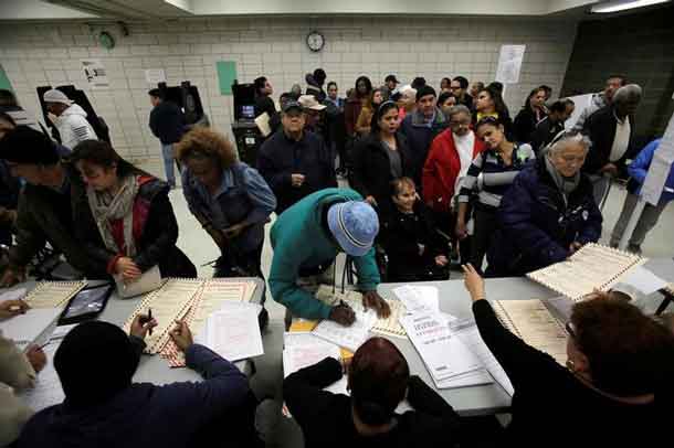 Voters register to vote during the U.S. presidential election at a polling station in the Bronx Borough of New York, U.S., November 8, 2016. REUTERS/Saul Martinez