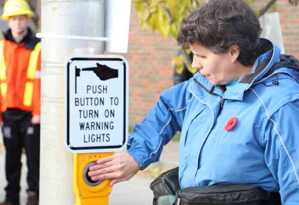 Push the button and cross the street - New crosswalk opened on Algoma Street