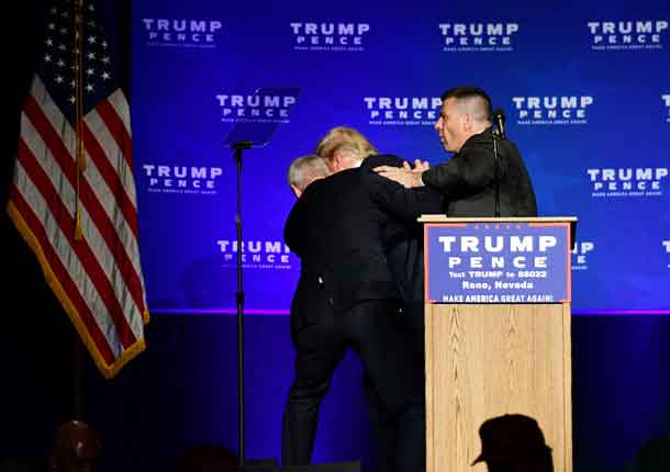 U.S. Republican presidential nominee Donald Trump is hustled off the stage by security agents after a perceived threat in the crowd, at a campaign rally in Reno, Nevada, U.S. November 5, 2016. REUTERS/Steven Styles