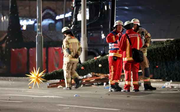 Paramedics and fire fighters talk beside a truck at a Christmas market in Berlin, Germany, December 19, 2016 after a truck ploughed into the crowded Christmas market in the German capital. REUTERS/Pawel KopczynskiParamedics and fire fighters talk beside a truck at a Christmas market in Berlin, Germany, December 19, 2016 after a truck ploughed into the crowded Christmas market in the German capital. REUTERS/Pawel Kopczynski