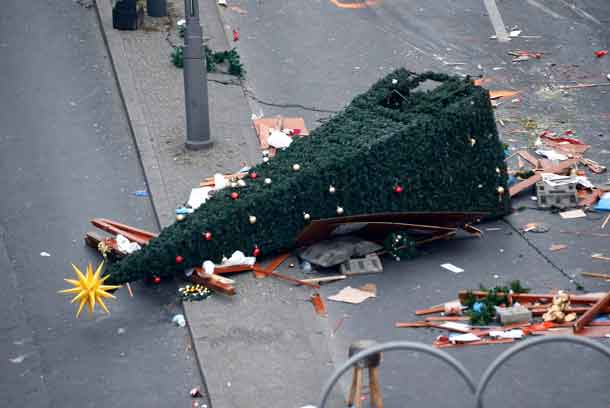 A christmas tree lays on the street beside the empty Christmas market in Berlin, Germany, December 21, 2016, after a truck ploughed through a crowd at the Christmas market on Monday night. REUTERS/Hannibal Hanschke