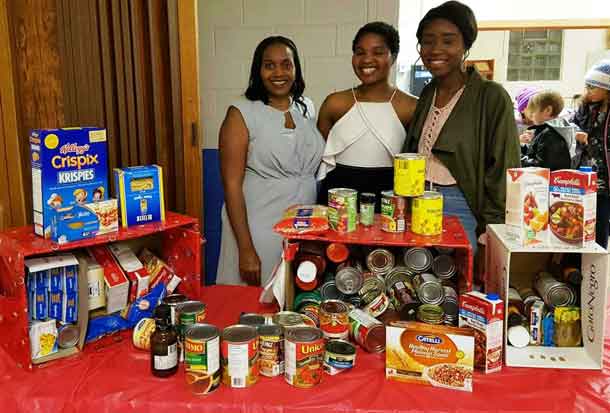 Dianna Atkinson, President of CAMAT; Takwana Nhau, Shelter House; Matilda Ankrah, President of the African Caribbean Student Association at LU. Food donations collected by CAMAT for the Shelter House Thunder Bay.