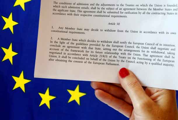 Article 50 of the EU's Lisbon Treaty that deals with the mechanism for departure is pictured near an EU flag following Britain's referendum results to leave the European Union, in this photo illustration taken in Brussels, Belgium, June 24, 2016. REUTERS/Francois Lenoir/Illustration/Files