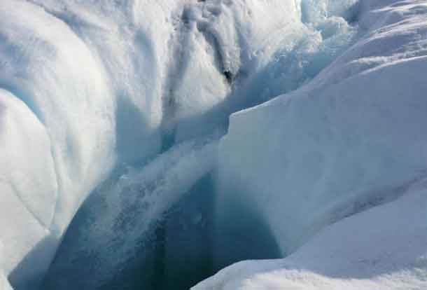Meltwater from the Greenland ice sheet can travel through channels in the ice to reach bedrock; a new study show where subglacial water goes. Here, water plunges down a moulin, or hole in the ice. CREDIT: Marco Tedesco/Lamont-Doherty Earth Observatory