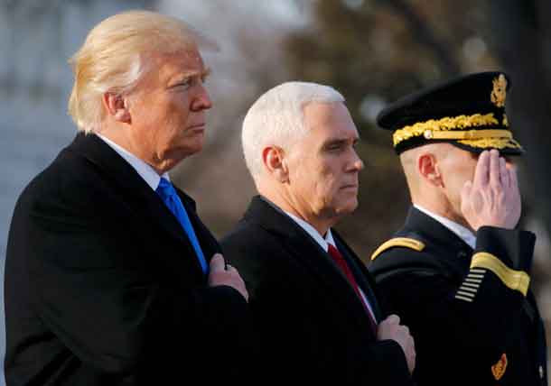 U.S. President-elect Donald Trump (L) and Vice President-elect Mike Pence (C) participate in a wreath laying ceremony at Arlington National Cemetery outside Washington, U.S., January 19, 2017, one day before Trump's inauguration as the nation's 45th president. REUTERS/Jonathan Ernst
