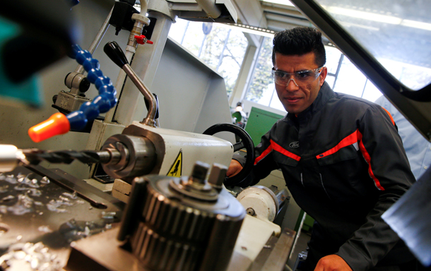 FILE PHOTO - Qudratullah Hotak, a 23-year-old refugee from Afghanistan works with a driller at the training workshop of Ford Motor Co in Cologne, Germany, November 3, 2016. REUTERS/Wolfgang Rattay/File Photo