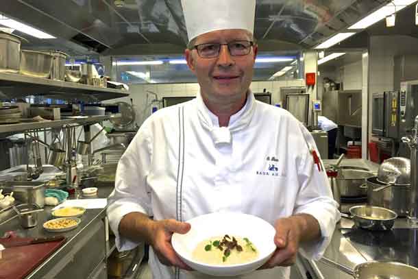 Chef Olivier Rais in his kitchen at Rive Gauche in Zurich's Hotel Baur au Lac with a serving of his vegan risotto. Credit: Copyright 2017 David A. Latt