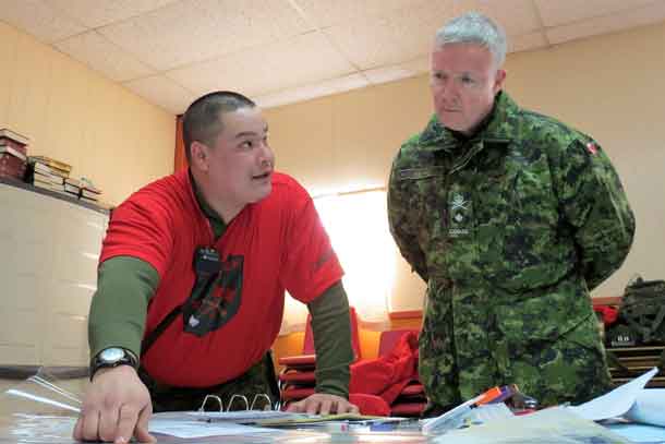 Master Corporal Byron Corston, left, briefs Brigadier-General Stephen Cadden on the progress of a search and rescue exercise
