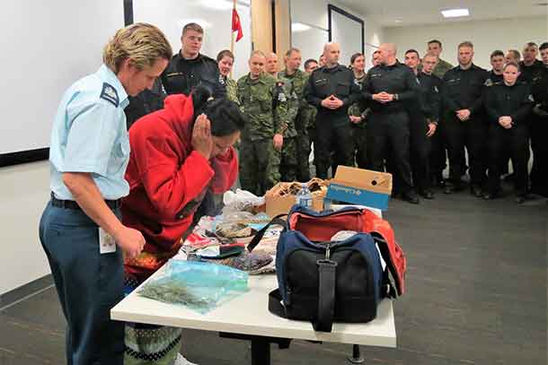 Master Corporal Florrie Sutherland, a member of the Constance Lake First Nation Canadian Ranger patrol, smudges during a talk at the Canadian Forces Military Police Academy.