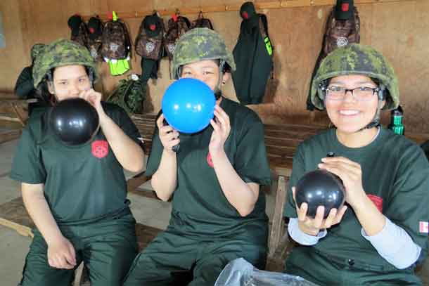 Junior Canadian Rangers blowing balloons up for target practice are, from left, Alyssa McKinney and Brianna Miles, both from Fort Severn, and Brianna Goodman from Sandy Lake.