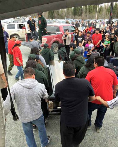 The body of Junior Canadian Ranger Josiah Begg is carried from a plane to a pick-up truck to be driven to the church for viewing.