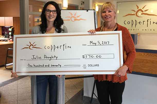 Julie Doughty receives her dividend cheque at the Copperfin Syndicate Branch