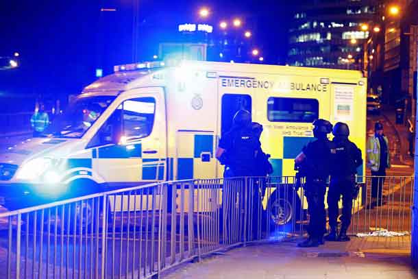 Armed police officers stand near the Manchester Arena, where U.S. singer Ariana Grande had been performing, in Manchester, in northern England, Britain May 23, 2017. REUTERS/Andrew Yates