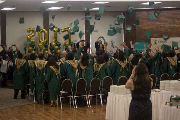 Oshki Graduates toss their caps in the time-honoured Tradition