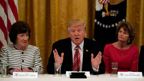 U.S. President Donald Trump meets with Senate Republicans about healthcare in the East Room of the White House in Washington, U.S., June 27, 2017. Trump is flanked by Senators Susan Collins (R-ME) and Sen. Lisa Murkowski (R-AK). REUTERS/Kevin Lamarque