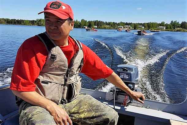 Sergeant Jason Roundhead of North Caribou Lake leads a group of Canadian Ranger boats on their way to Quicksand Rapids. credit: Major Douglas Ferguson