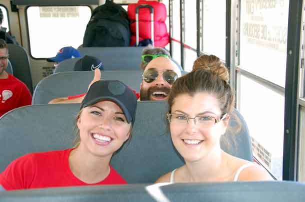 Volunteers Kara (left) and Dan, as well as camper Neave are ready for the bus ride to camp