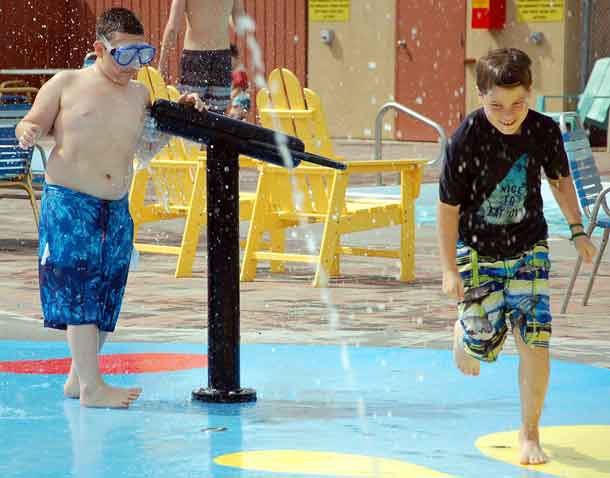 Camper Ali (left) getting ready to spray camper Gryphon in the splash pad at KOA!