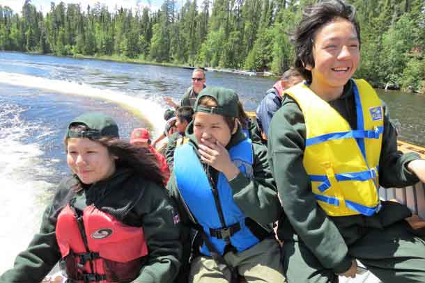 Junior Canadian Rangers react to a sharp turn in a power boat.
