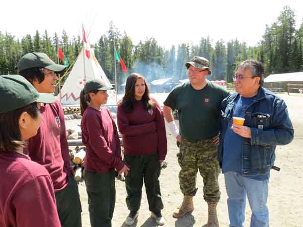 Chief Brennan Sainnawap of Wapekeke First Nation, right, talks with Junior Canadian Rangers during a visit to Camp Loon, a Junior Ranger training camp. credit: Sergeant Peter Moon, Canadian Rangers