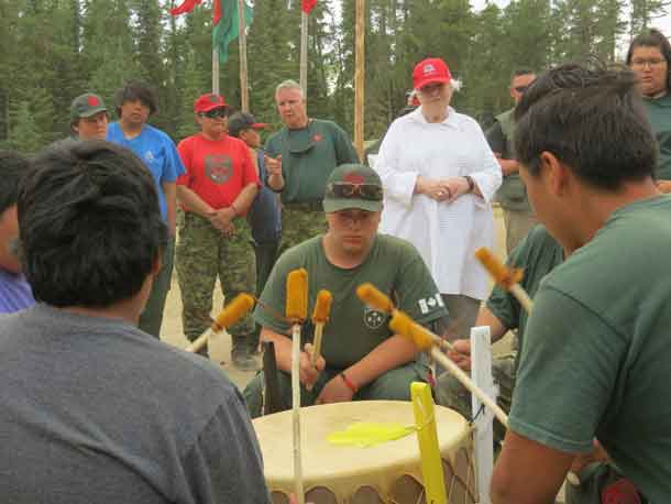 Ontario Lieutenant-Governor Elizabeth Dowdeswell, in white at right, listens to a drum group during her visit to Camp Loon. -- 