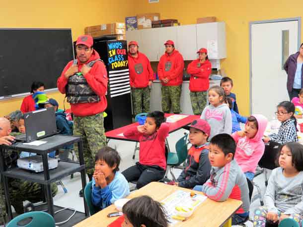 Students watch a PowerPoint presentation while Ranger Redfern Wesley talks about the importance of life jackets. Photo Sgt. Peter Moon