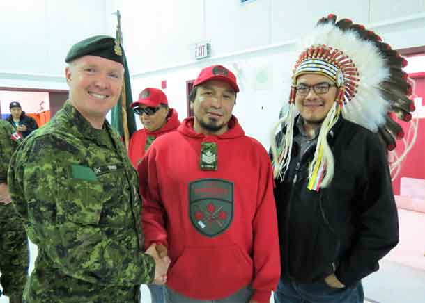 Brigadier-General Stephen Cadden, left, congratulates Sergeant Paul Oskineegish, centre, on become his patrol's new commander, along with Chief Johnny Yellowhead, right - Photo Sgt. Peter Moon