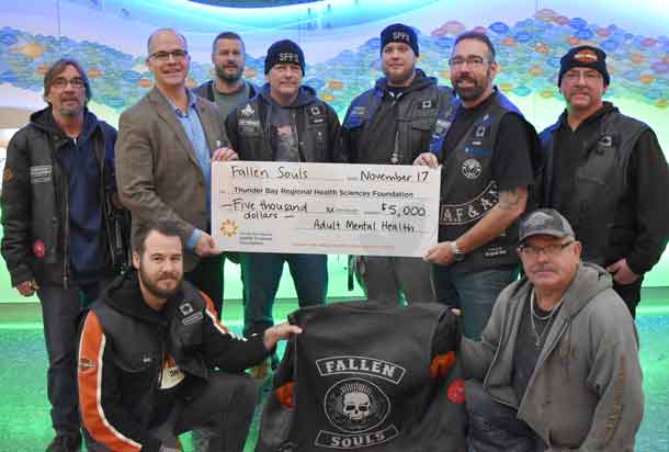 Members of the Fallen Souls Riding Association proudly present Dr. Peter Voros, Director of Forensic and Mental Health, with a cheque for $5,000.