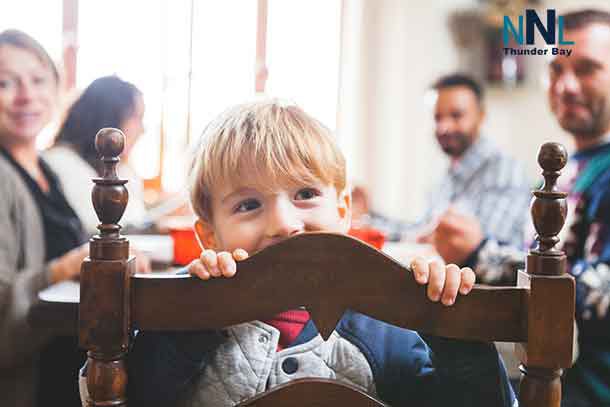 A family gathers around the table to enjoy dinner at home.