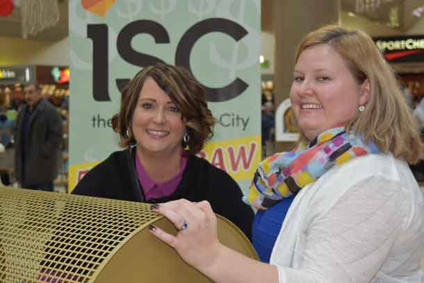 Stacey Ball, General Manager, Intercity Shopping Centre (left) pulls the winning ticket in the 18th annual Intercity Shopping Centre 50/50 Cash Draw. She is joined by Devon Sokoloski, Special Events Officer, Thunder Bay Regional Health Sciences Foundation.