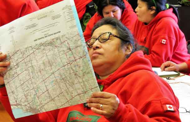 Corporal Harriet Cutfeet of Kitchenuhmaykoosib checks a map during a class on navigation.