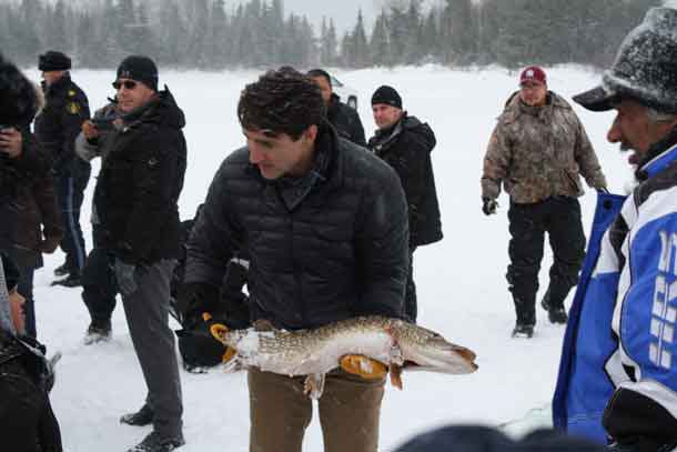 Prime Minister Trudeau with one of the Northern Pike caught in a gill net in Pikangikum during his visit