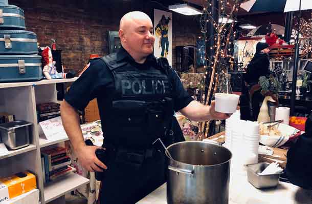 Serving up the delicious stew from Excuria an officer from the Thunder Bay Police Service engages with community