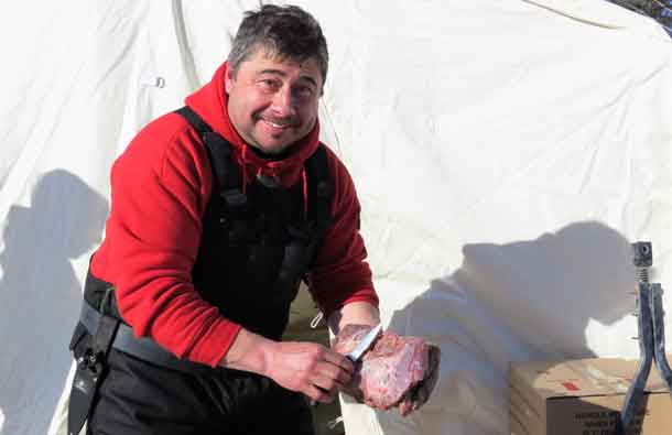 Corporal Michael Pelletier of Mishkeegogamang First Nation prepares meat for a moose stew. Photo by Sgt. Peter Moon