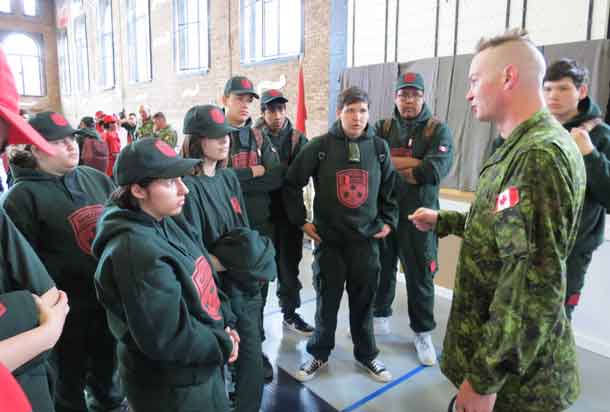 Warrant Officer Ron Wen talks with members of the Northern Ontario shooting team.