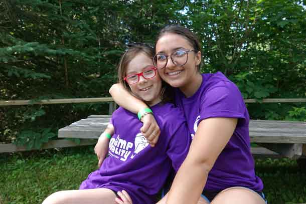 Camper Lilly with volunteer Madison posing this morning for camp photos.