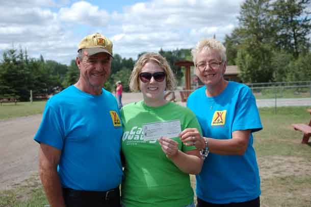 Camp director Ashleigh with Mike and Kristy from KOA, accepting their generous donation to our camp.