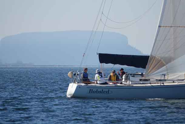 Campers Braeden and Connor out sailing with volunteer Kaitlyn.