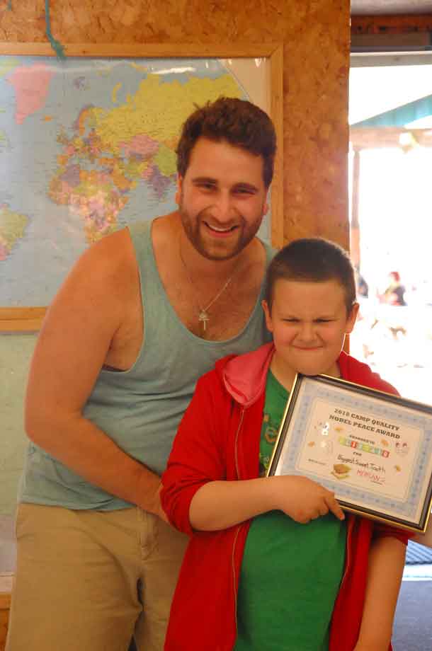 Camper Ali showing off the “Sweet Tooth” award he received from his companion Mehran.