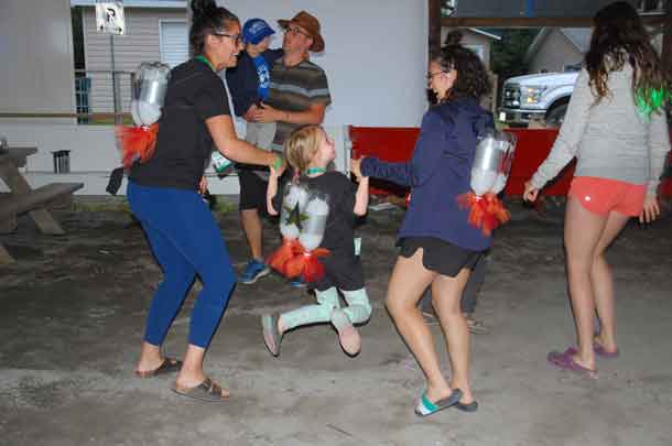 Camper Ally dancing the night away with volunteers Meaghan and Madison