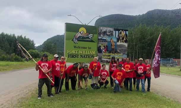 Spirit Walkers at the Fort William First Nation sign after crossing the James Street Bridge.