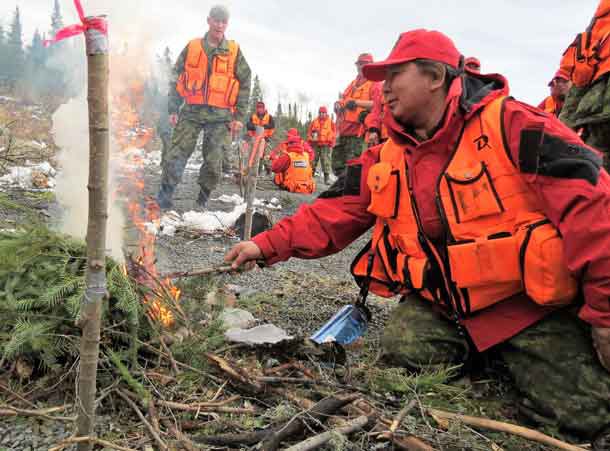 Master Corporal Yvonne Sutherland of Kashechewan practices lighting a fire quickly to warm a search victim.