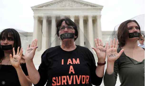 Women stand in silent protest outside the U.S. Supreme Court building after the U.S. Senate voted to confirm the Supreme Court nomination of Judge Brett Kavanaugh on Capitol Hill in Washington, U.S., October 6, 2018. REUTERS/Jonathan Ernst