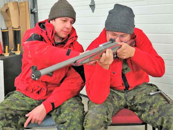 Ranger Austin Baxter and Master Corporal Donny Sutherland get a feel for one of the new Canadian Ranger rifles delivered to Constance Lake.