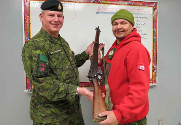 Lieutenant-Colonel Matthew Richardson,left, presents one of the old Ranger .303 rifles as a gift to Sergeant Neil Neegan of the Constance Lake Ranger patrol.