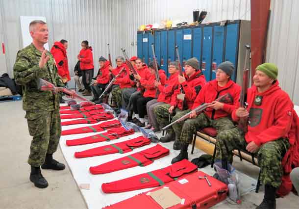 Warrant Officer Chris Thomson, an army instructor, trains Canadian Rangers in Constance Lake in the use of the new Ranger rifle.
