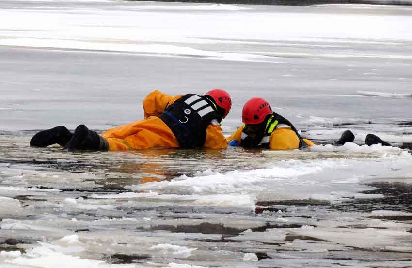 A rescuer, left, reaches a soldier "victim." - image: Sgt Peter Moon