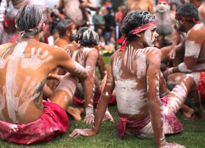 Members of Koomurri Aboriginal Dance Troupe participate in a traditional Australian Aboriginal smoking ceremony as part of celebrations for Australia Day, which marks the arrival of Britain's First Fleet in 1788, in central Sydney, Australia, January 26, 2018. REUTERS/Steven Saphore