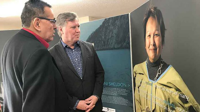 Minister Feehan (right) and Adam North Peigan view Bi-Giwen:Coming Home- Truth Telling From the Sixties Scoop exhibit